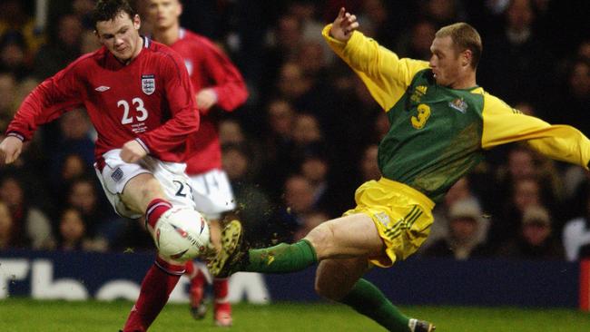 Craig Moore gives Wayne Rooney no space in a classic England-Australia encounter.