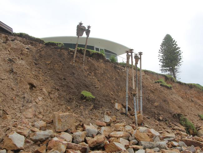 Two homes have partially collapsed during high tides and rough seas at Wamberal Beach.