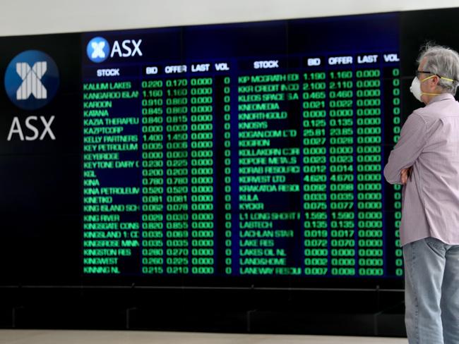 SYDNEY, AUSTRALIA - NewsWire Photos OCTOBER 21, 2020: A man pictured in a mask looking at the screens  at the Australian stock exchange, Sydney CBD. Australian stocks are tipped to open higher after gains on Wall Street, where major indexes were higher in afternoon trade on renewed stimulus hopes.Picture: NCA NewsWire / Damian Shaw