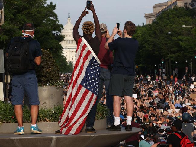 Demonstrators lay down on Pennsylvania Avenue during a peaceful protest against police brutality and the death of George Floyd in Washington, DC. Picture: Getty