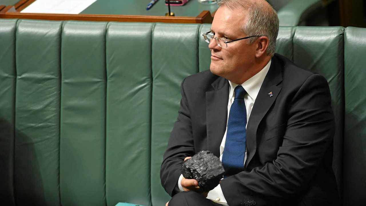 Australia's Treasurer Scott Morrison pictured holding a piece of coal during House of Representatives Question Time at Parliament House in Canberra, in February. Picture: LUKAS COCH