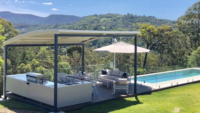 Couples can relax by the pool as they take in the pristine view at this Piggabeen Airbnb.