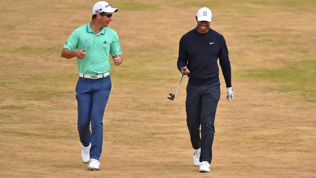 Lucas Herbert and Tiger Woods share a laugh during a practice round at Carnoustie.