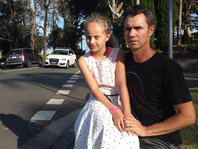 Resident Geoff Channells, pictured with daughter Hayden, 9, fears another fatality at the intersection of Scenic Highway and Bellevue Cres unless safety improvements are urgently made.