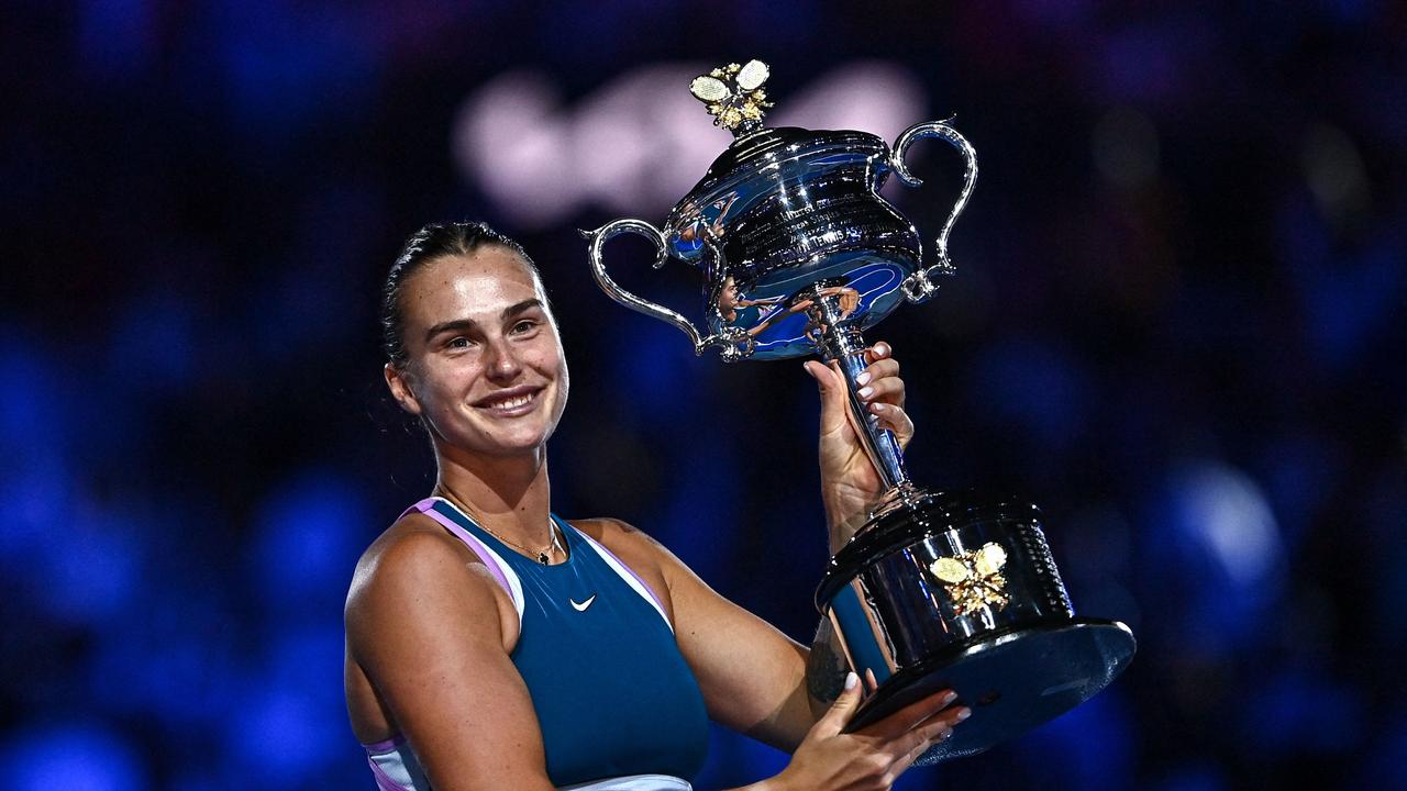 Belarus' Aryna Sabalenka celebrates with the Daphne Akhurst Memorial Cup. Photo by MANAN VATSYAYANA / AFP.