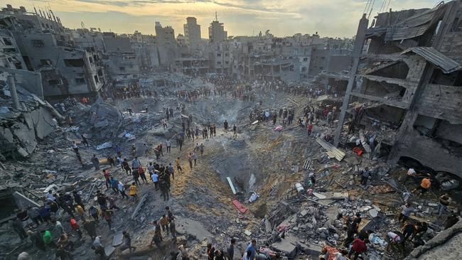 Palestinians survey the damage following the airstrike on a Hamas position at the Jabalia refugee camp in the northern Gaza Strip. Picture: Reuters