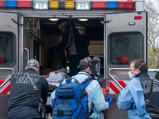 NEW YORK, NY - APRIL 20: Fire Department of New York medical staff attend to an elderly person experiencing difficulty breathing outside of an apartment building on April 20, 2020, in New York City. NYC Mayor Bill de Blasio announced during his daily COVID-19 briefing that the city has had a big drop in 911 emergency medical calls after a surge during the peak of the pandemic.   David Dee Delgado/Getty Images/AFP == FOR NEWSPAPERS, INTERNET, TELCOS & TELEVISION USE ONLY ==