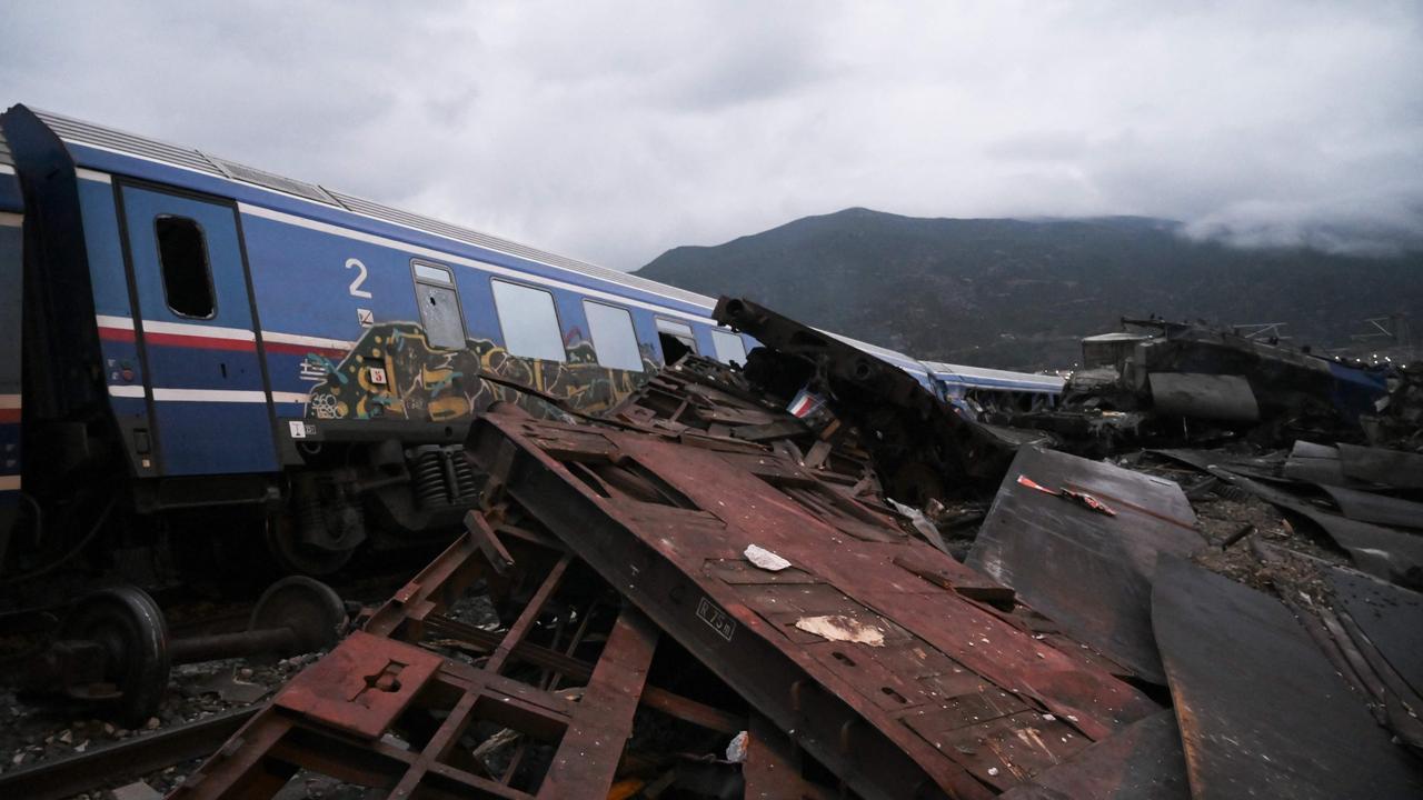 Wrecked wagons and mangled pieces of metal are seen near the tracks after a train accident in the Tempi Valley near Larisa, Greece. Picture: AFP.