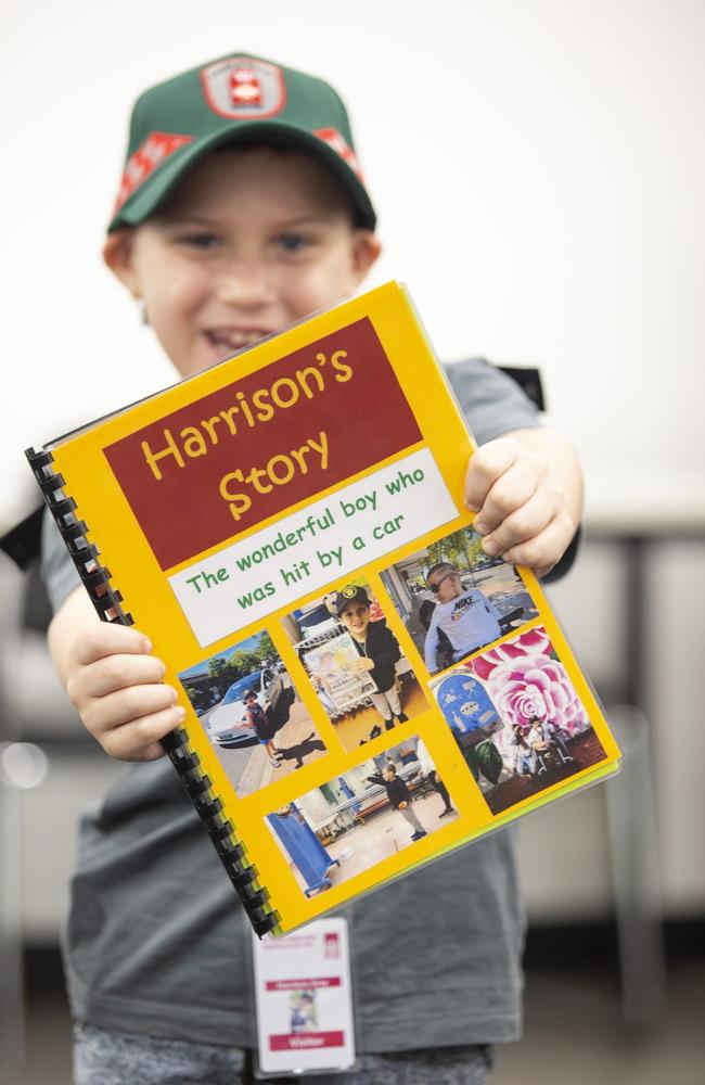 Darwin boy and survivor Harrison Grey with his journey book he created with his specialist. Picture: Floss Adams