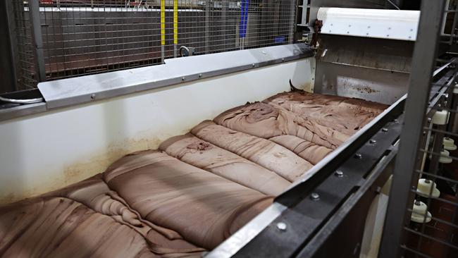 Chocolate being mixed together for Tim Tam production at the Arnott’s factory. Picture: Adam Yip