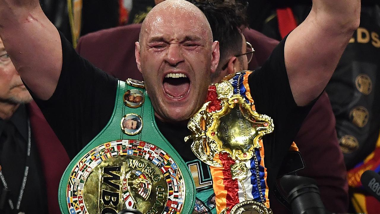 Tyson Fury celebrates after defeating US boxer Deontay Wilder. (Photo by Mark RALSTON / AFP)