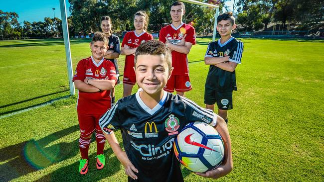 Campbelltown City Soccer Club players Jean-Paul, 9, Jamie, 9, Alysia Covino, 19, Leena, 16, Adrian, 14, and Marco, 12. Picture: AAP/Roy VanDerVegt