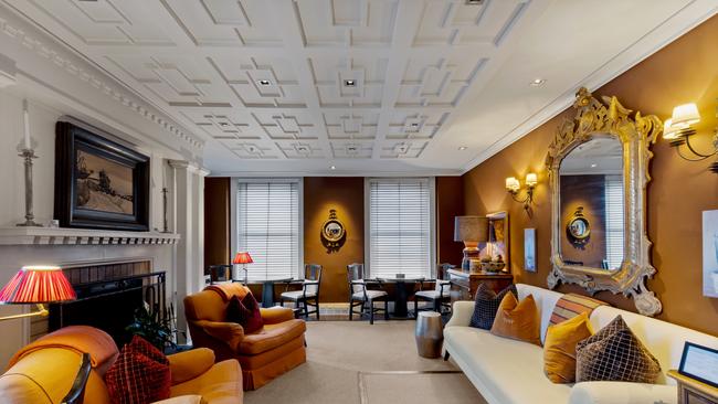 The hotel lounge is filled with rich colours and plush furnishings.