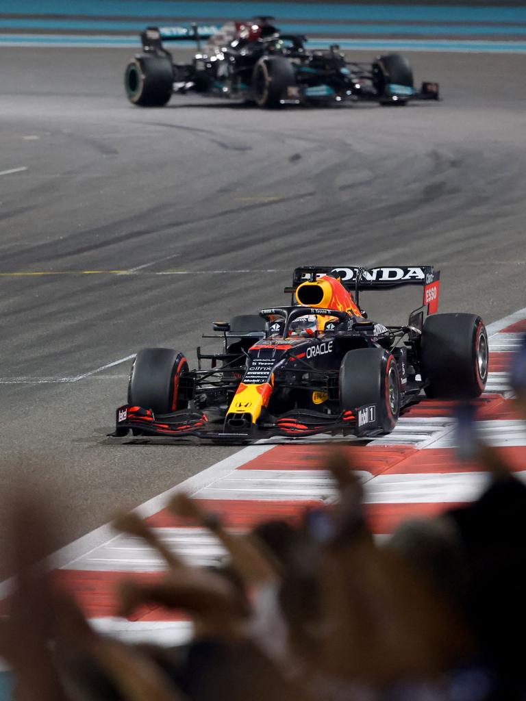 Verstappen crosses the line ahead of Hamilton. (Photo by Giuseppe CACACE / AFP)