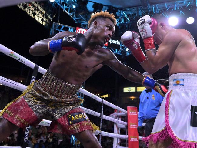 Jernell Charlo (gold/red shorts) exchanges punches in the ring with Brian Castano (white/pink shorts) during their super middleweight title fight on May 14, 2022. Picture: Jayne Kamin-Oncea/Getty Images