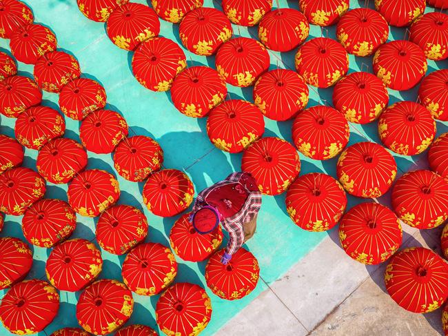 A worker in Huai’an, China, crafts red lanterns for the upcoming Lunar New Year celebrations. Picture: AFP