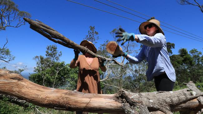 Jessica Power, from Paris France, and mum Kate, lend a hand to help open the Main Western Rd at Mt Tamborine. Picture: NCA Newswire / Scott Powick