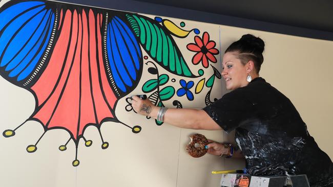 After opening last October, bagel shop Bury Me Standing has expanded to include a dining area. Bury Me Standing co owner Alesha Peckels works on a wall mural in the new dining area. Picture: Brendan Radke