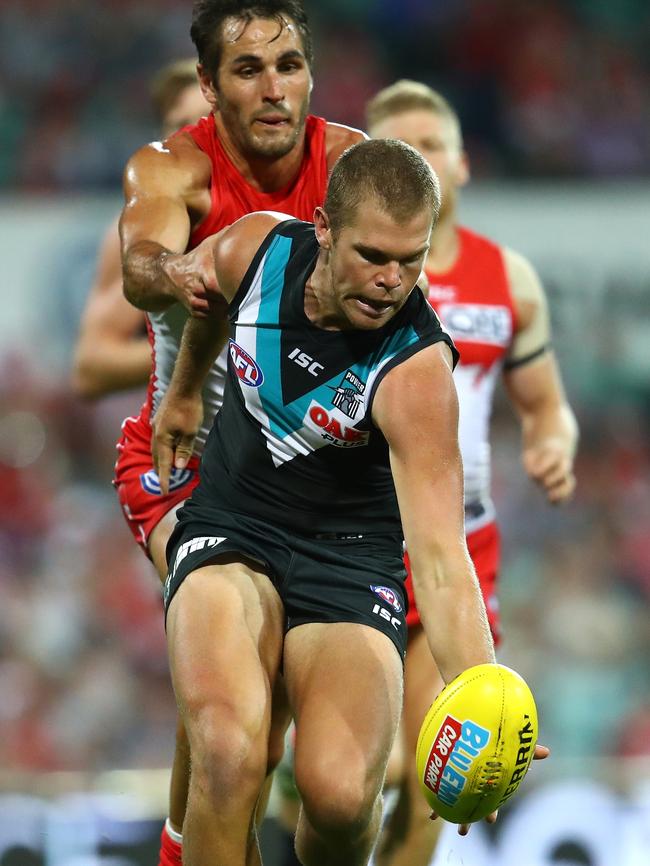 Tom Clurey gathers the ball under pressure from Josh Kennedy during the round two AFL match between the Sydney Swans and the Port Adelaide Power. Picture: Cameron Spencer/Getty Images