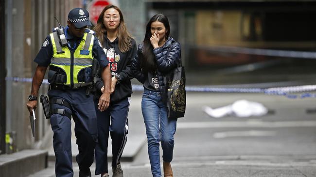 A body lays under a tarp as police evacuate the public. Picture: David Caird