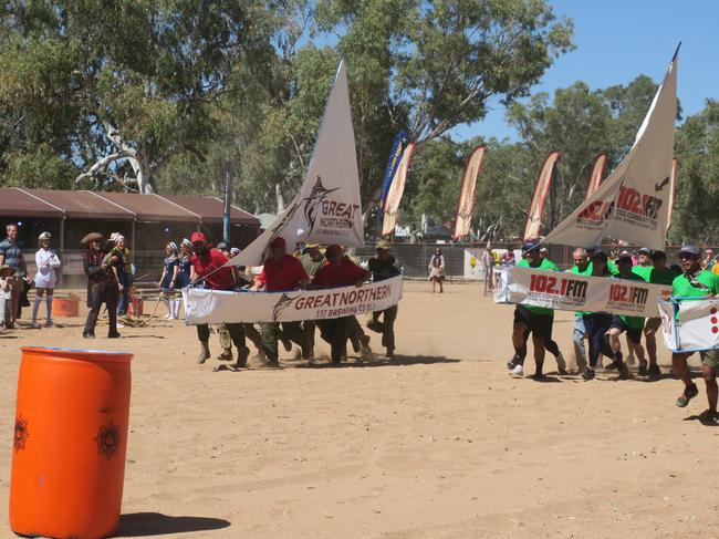 Teams raced around empty barrels on a dry Todd River in the KFC Maxi Yacht race. Picture: Laura Hooper.