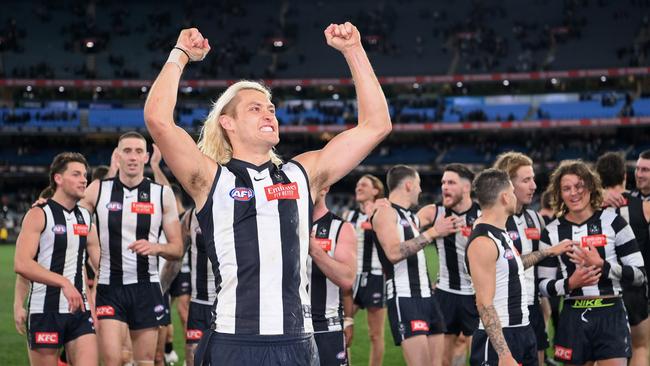 Darcy Moore celebrating with Pies fans. Picture: Quinn Rooney/Getty Images