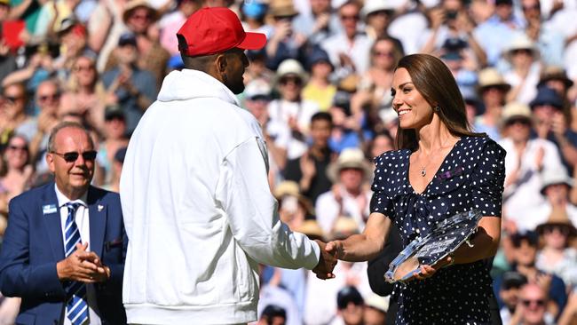 Australia's Nick Kyrgios receives the runner-up's trophy from the Duchess of Cambridge. Picture: Sebastien Bozon/AFP