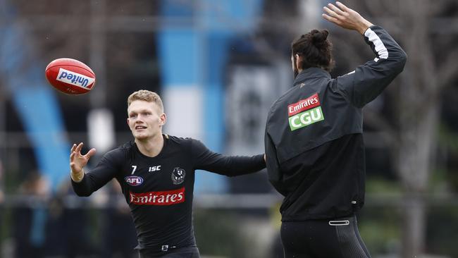 Adam Treloar, left, and Brodie Grundy at work during Collingwood training.