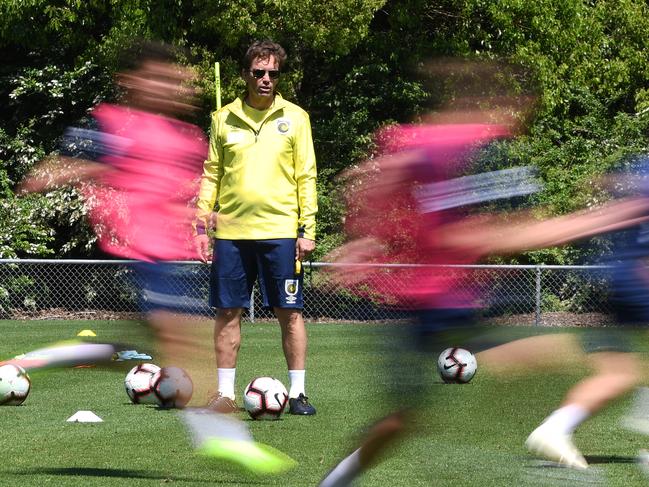 The Central Coast Mariners coach Mike Mulvey watches his playing squad during a training session at their training base in Gosford, Tuesday, October 23, 2018. Olympian Usain Bolt did not train with the team as negotiations regarding a player contract continue. (AAP Image/Dean Lewins) NO ARCHIVING