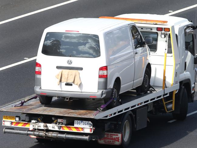 Several gunshot holes can be seen in the driver’s side door as Paul Virgona’s van is taken away on the back of a tow truck. Picture: David Crosling