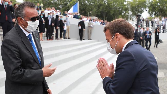 French President Emmanuel Macron (R) greets World Health Organization (WHO) Director-General Tedros Adhanom Ghebreyesus (L) at the end of the annual Bastille Day military ceremony on the Place de la Concorde in Paris. Picture: AFP.