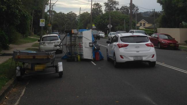 A trailer tipped on its side at Pittwater Road Mona Vale. Picture: Bill Ditmarsch