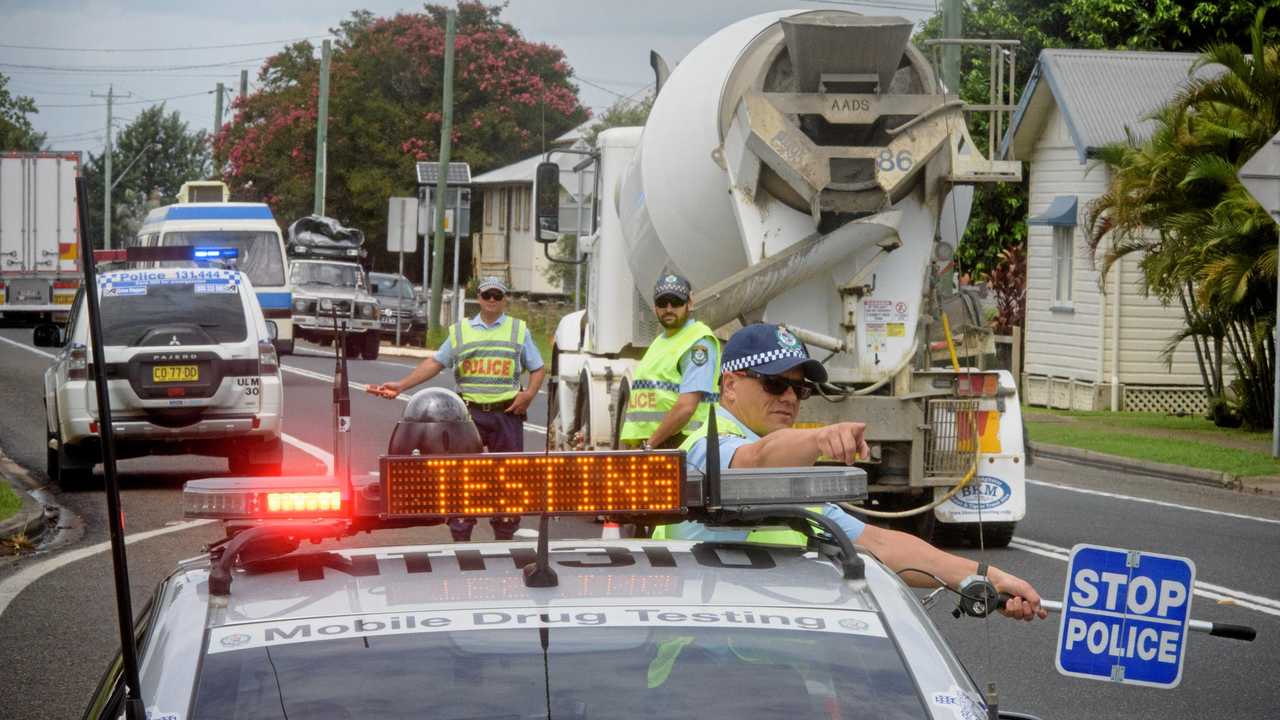 Sergeant Jarrod French of Coffs Clarence Highway patrol directs drivers in for Random Breath Testing at Ulmarra. Picture: Adam Hourigan Photography