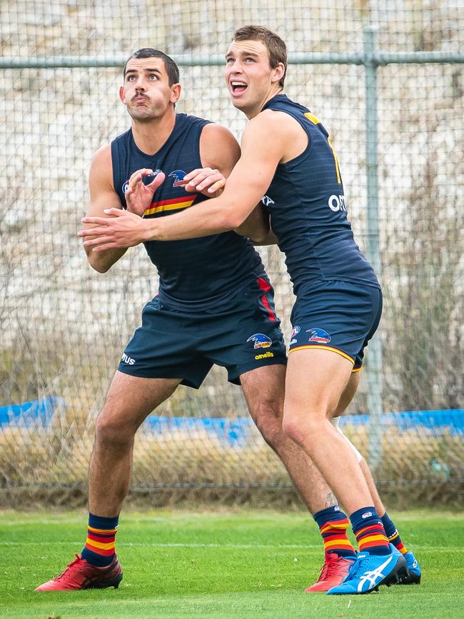 Taylor Walker and Riley Thilthorpe battle it out in a one-on-one at training. Picture: Tom Huntley