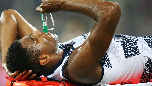 Esava Ratugolea of the Cats reacts in pain after injuring himself.