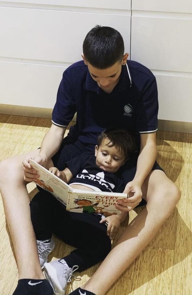 Jai Wright reading a story to his four-year-old brother. Picture: Supplied