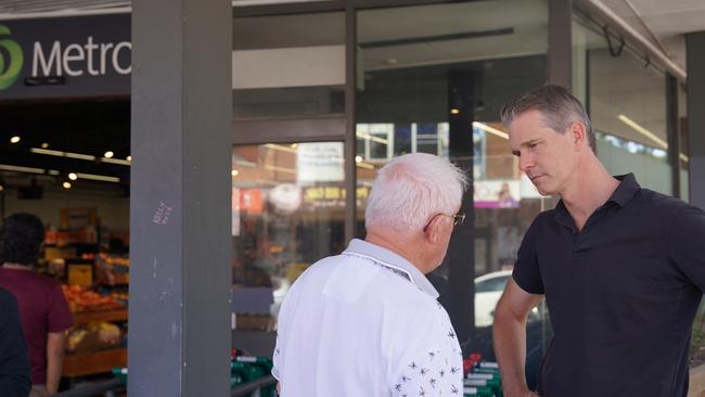 Parramatta federal Labor MP Andrew Charlton, right, with customers outside Pendle Hill Woolworths Metro, many who are elderly.