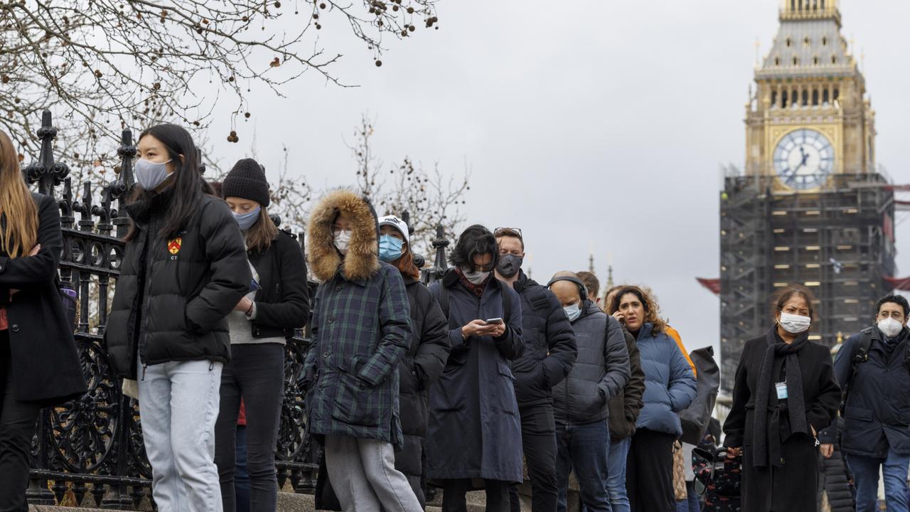 People queue outside a walk-in Covid-19 vaccination centre at St Thomas's Hospital in Westminster.