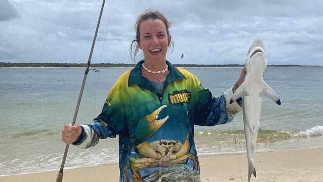 Avid fisher Sammie Holland with a black tip reef shark she snagged the day before catching her “dream” golden trevally.