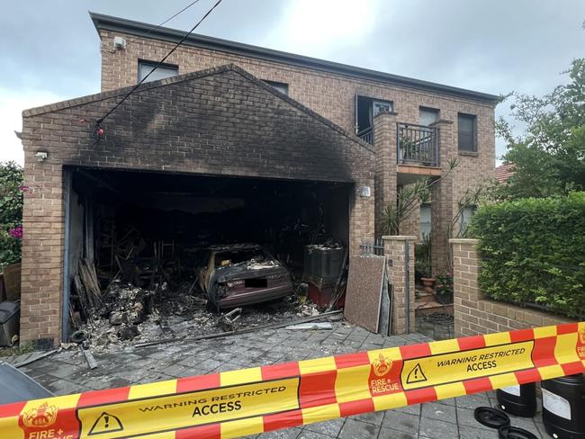 The home was significantly damaged, with a car in the garage completely destroyed. Picture: FRNSW