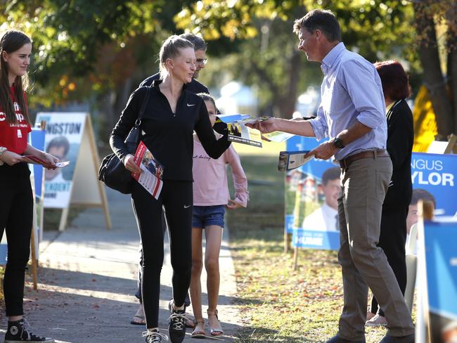 Hume MP Angus Taylor hands out how to vote pamphlets at Camden Public School polling booth on Saturday. Picture: Robert Pozo