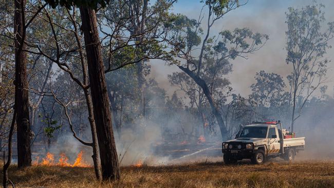 ABOUT eight properties were under threat in the Livingstone area as a bushfire ripped through the area. Three aircraft, four helicopters and 20 volunteer crews and Bushfires NT fireys battled together to contain the blaze on Perentie Rd. one firefighter was injured an admitted to hospital with burns. Picture: Che Chorley