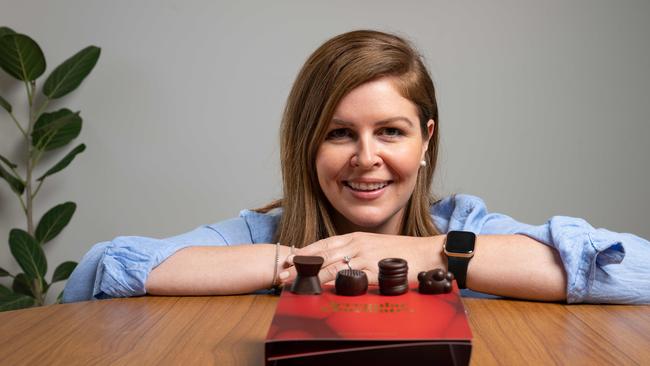 Bowel cancer survivor Elise Stapleton with the "irregular chocolates" being launched to encourage people to talk about bowel movements. Picture: Brad Fleet