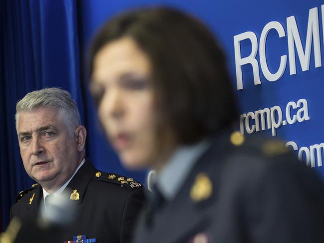 Royal Canadian Mounted Police Assistant Commissioner Kevin Hackett, left, listens as Sergeant Janelle Shoihet addresses media on July 23. Picture: Darryl Dyck/The Canadian Press via AP