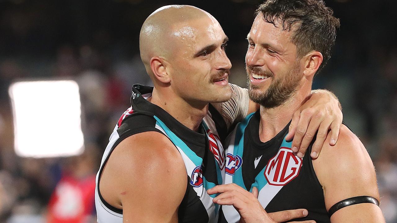 Sam Powell-Pepper hugs Travis Boak who will play on in 2024. (Photo by Sarah Reed/AFL Photos via Getty Images)