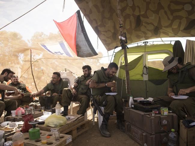 Israeli soldiers of the artillery unit rest in their tent at the Israeli side of the border with the Gaza Strip. Picture: Getty Images