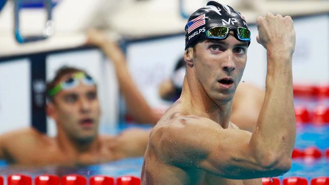 Michael Phelps of the United States celebrates winning gold.