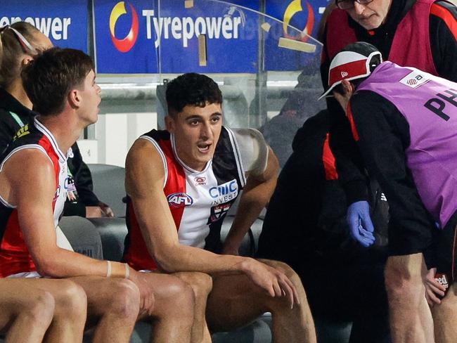Anthony Caminiti being assessed by trainers. Picture: Russell Freeman/AFL Photos via Getty Images.