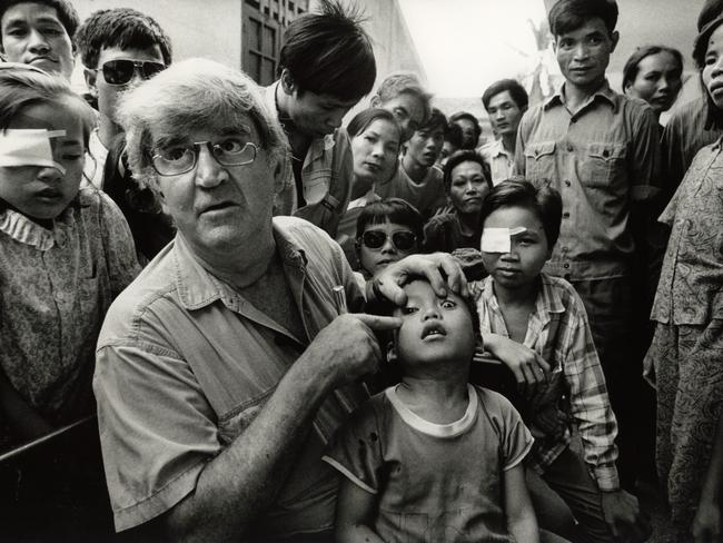 The iconic image of Professor Fred Hollows examining the eye of seven-year-old Tran Van Giap in Vietnam in 1992.