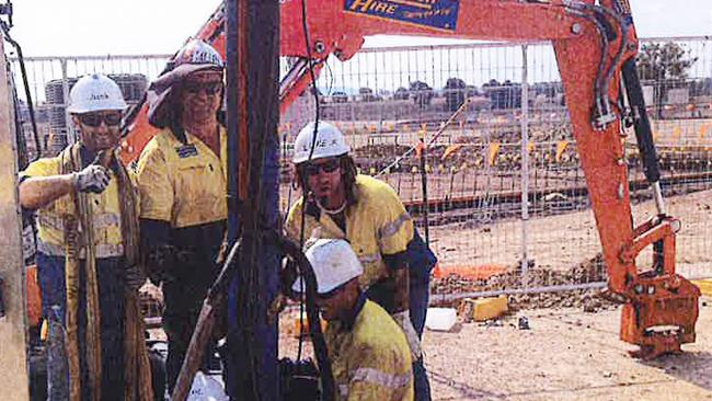 Glenn Newport, second from left, at work in the gasfields near Roma.